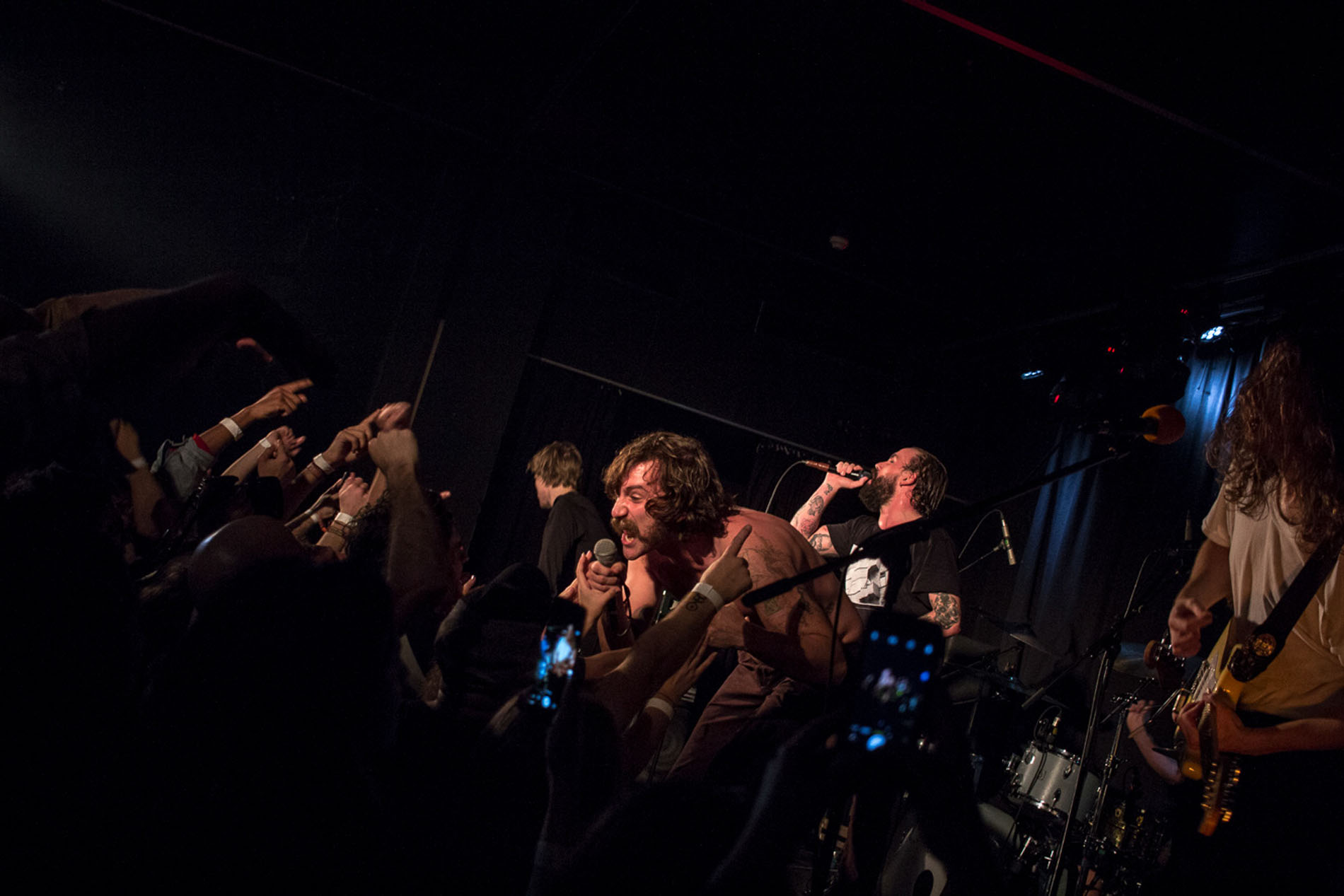 Performer singing among the audience during the IDLES concert at Hard Club.