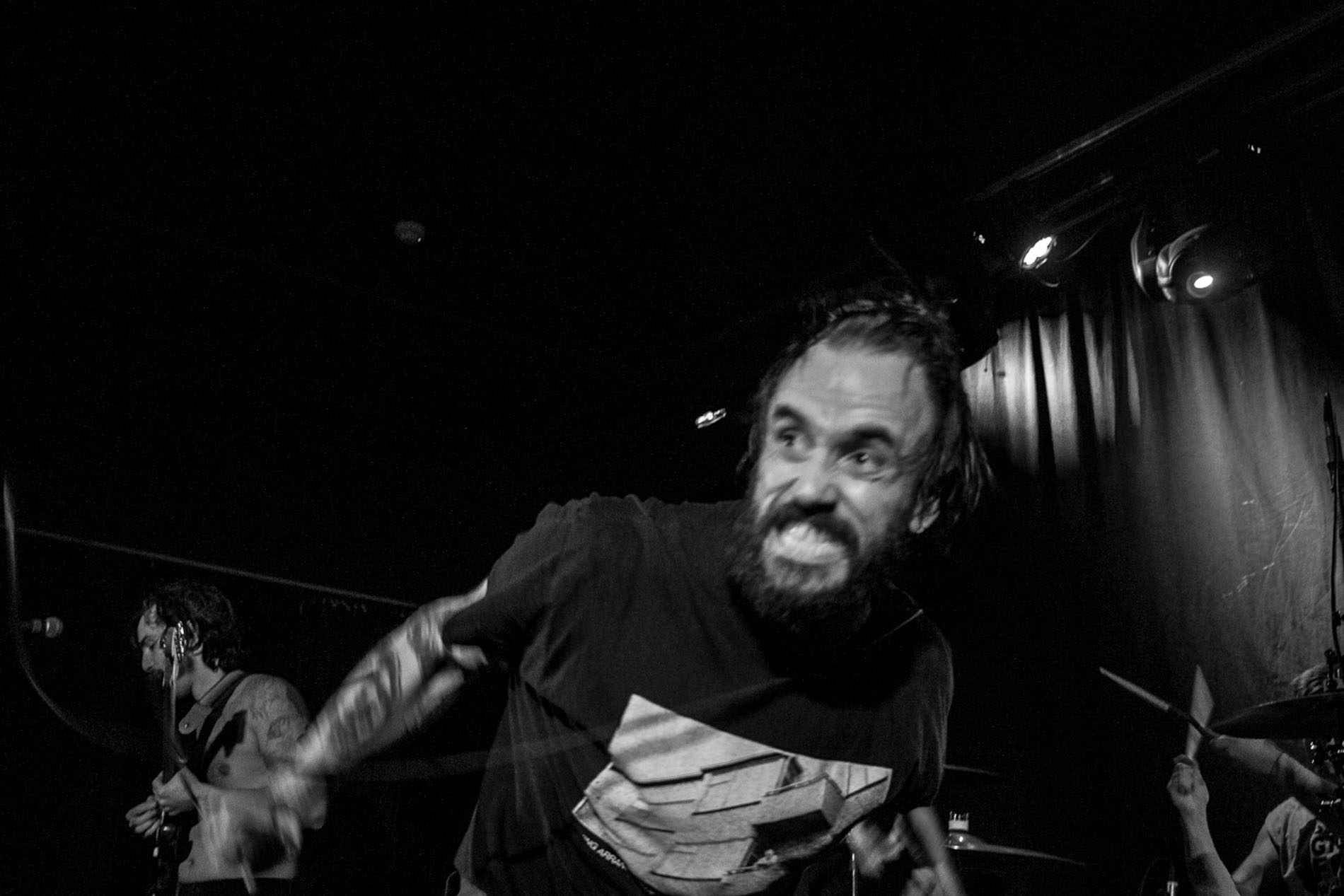 IDLES vocalist moving toward the audience during the Hard Club concert.